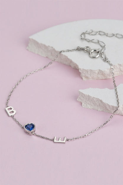 Pulsera con inicial de piedras preciosas de corazón de plata